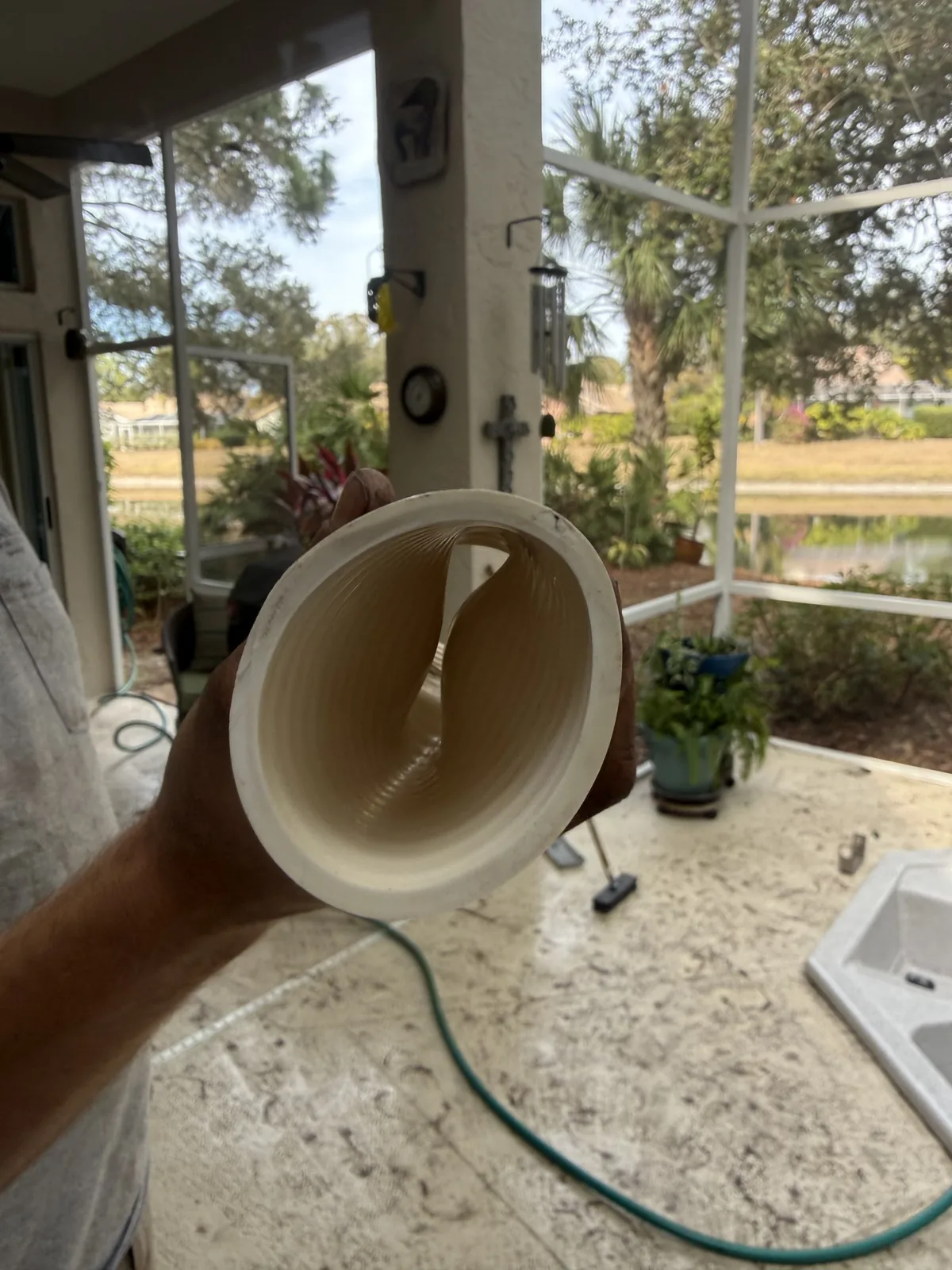 Cracked PVC pool plumbing fitting removed by Advanced Leak Detection, the hidden cause of major water loss