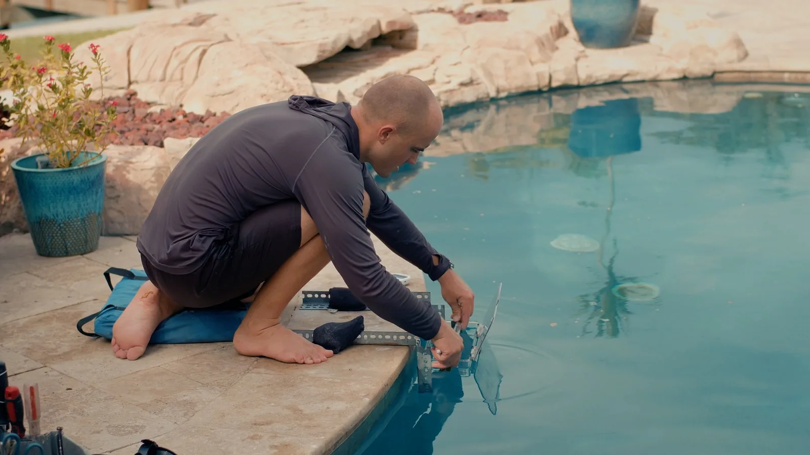 Advanced Leak Detection technician dye testing the edge of a pool during a leak inspection in Tampa Bay