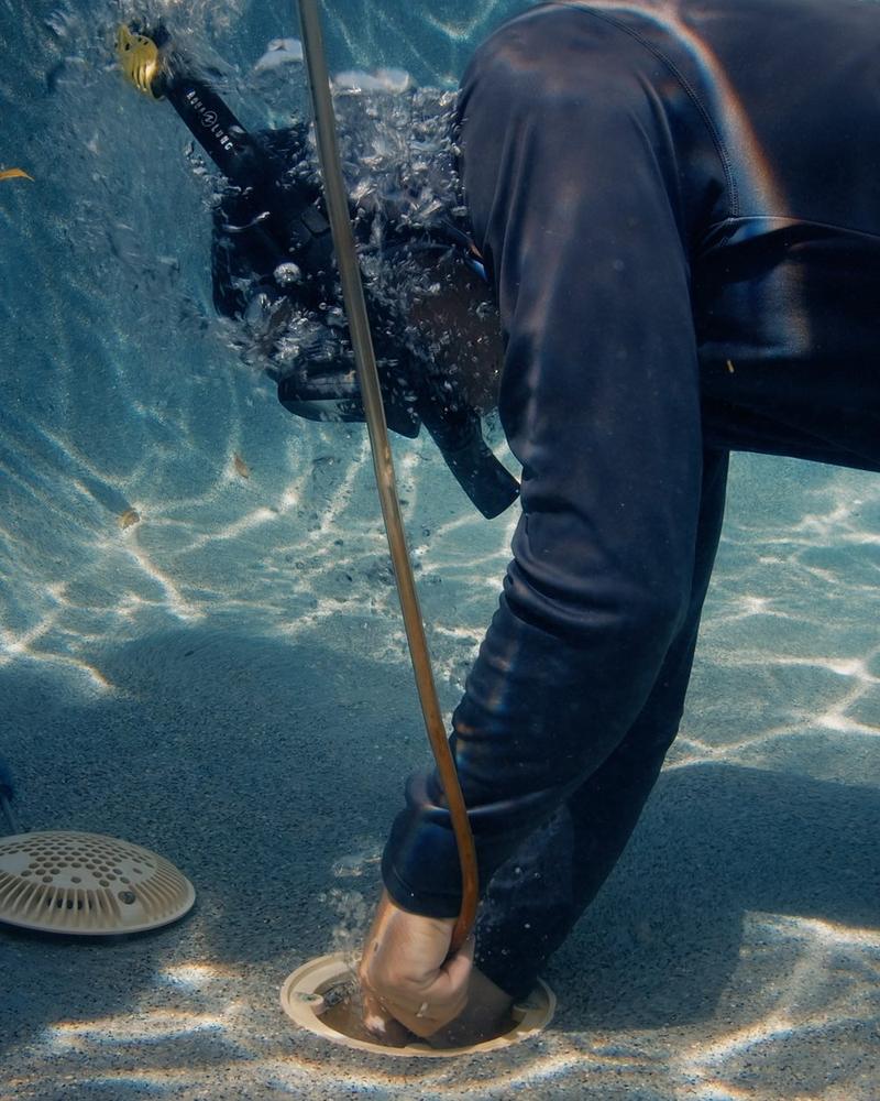 Advanced Leak Detection technician repairing a pool leak underwater without draining the pool — Tampa Bay & Sarasota