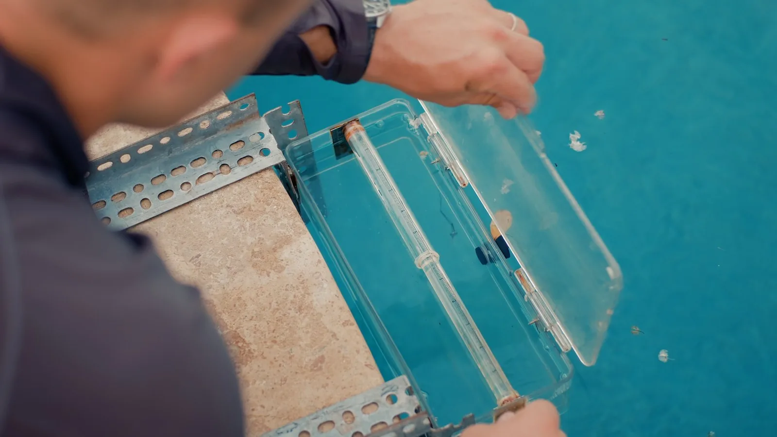 Clear acrylic dye testing box used to check a pool skimmer for leaks during an Advanced Leak Detection inspection