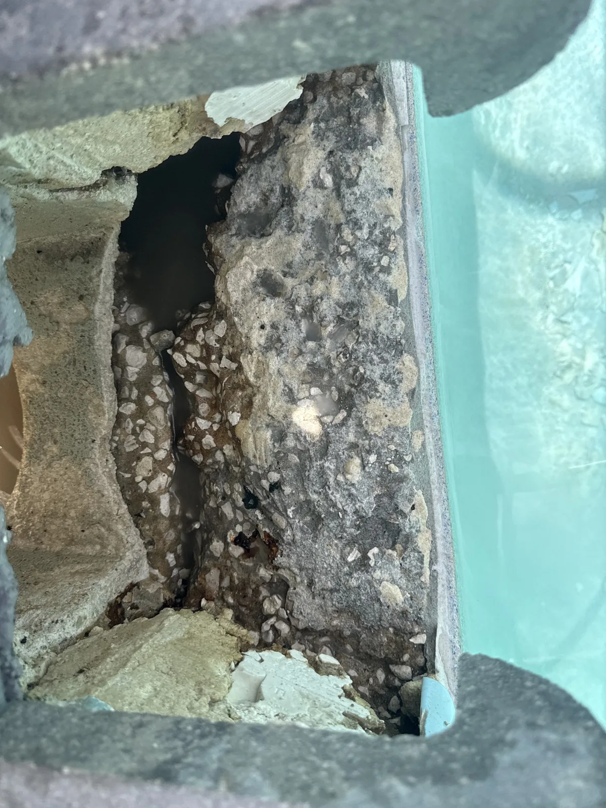 Leaking pool skimmer throat opened up for repair using the Deck Saver method by Advanced Leak Detection